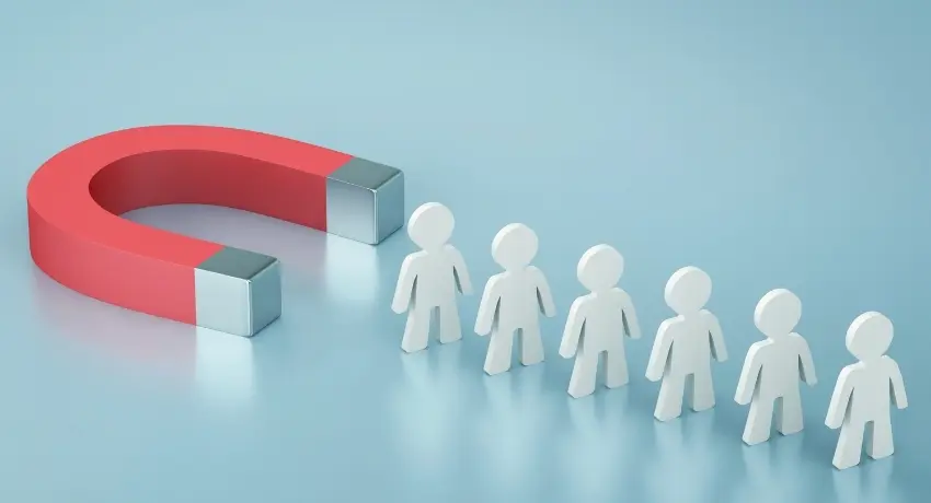 Ímã vermelho em formato de ferradura atraindo uma fila de figuras humanas brancas, representando atração de clientes.